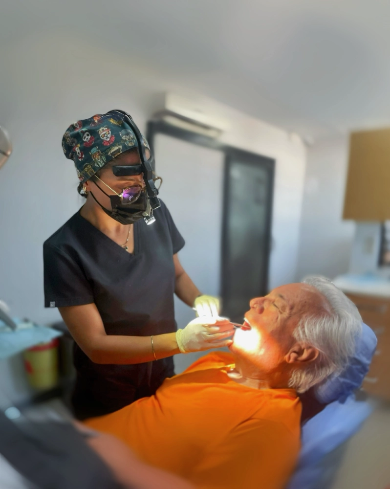 Dentist performing a dental treatment on a senior patient at Auraliss Health Antalya